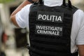 Details with the vest of a Romanian police officer with the text Ã¢â¬ÅPolitia. Investigatii CriminaleÃ¢â¬Â Police. Crimnial